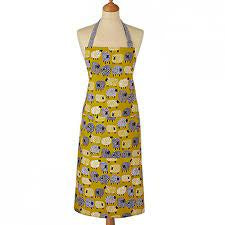 Ulster Weavers cotton apron with a Dotty Sheep print in mustard yellow, shown on a mannequin