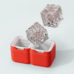 Zoku Luxe ice mould set in red with two cut crystal style ice cubes above it