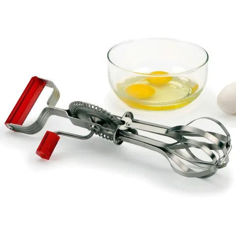 RSVP egg beater with a red crank handle and dual whisk heads, shown beside a bowl of eggs