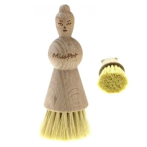 Florence Miss Pot brush, a wooden pot brush shaped like a lady with bristles, shown with a spare head
