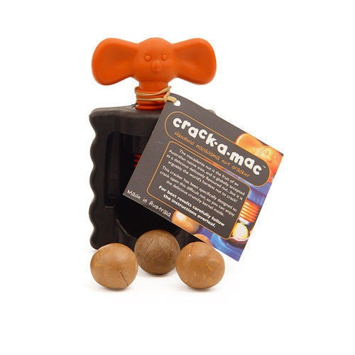 Crack-A-Mac macadamia nut cracker in black and orange, shown with macadamia nuts