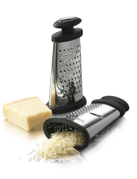 Boska Trio Formaggio grater in stainless steel and black, shown with a block of parmesan and grated cheese