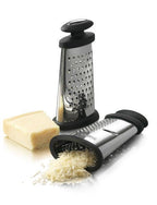 Boska Trio Formaggio grater in stainless steel and black, shown with a block of parmesan and grated cheese