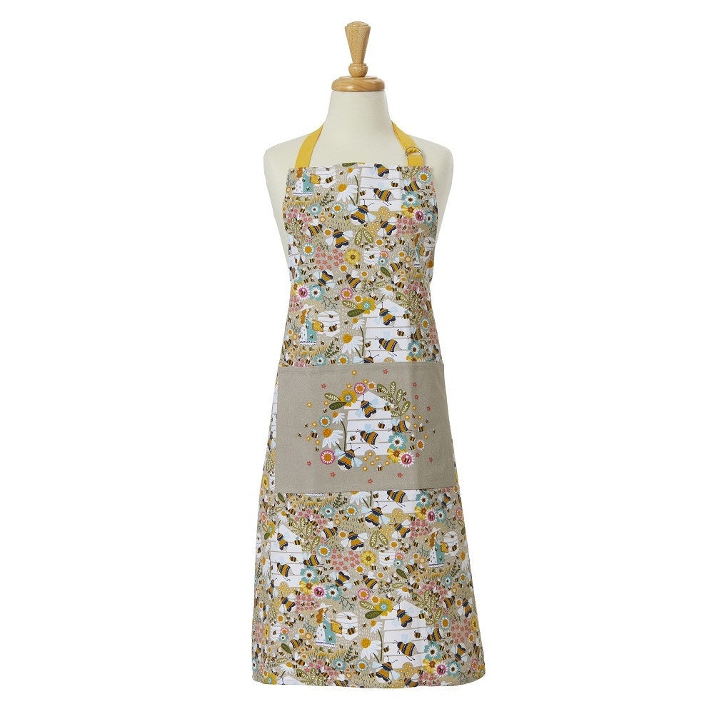 Ulster Weavers cotton apron with a Beekeeper print of flowers and bees and a beehive pocket, shown on a dress form