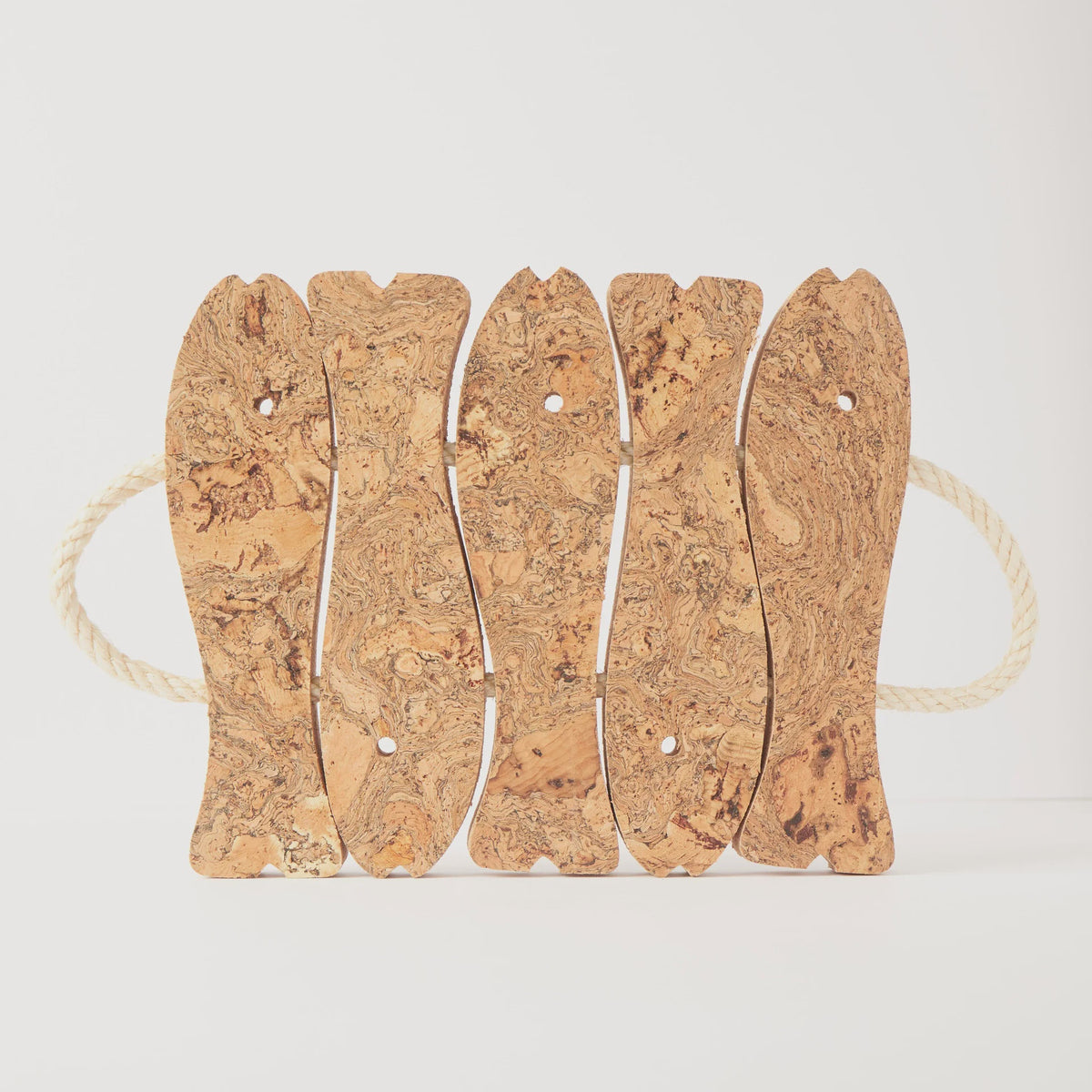 Liga natural cork trivet made of five linked fish shapes with rope handles