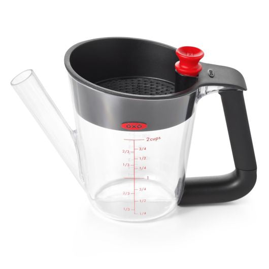 OXO Good Grips 500ml fat separator with a clear jug, a black strainer, a red release and a long spout