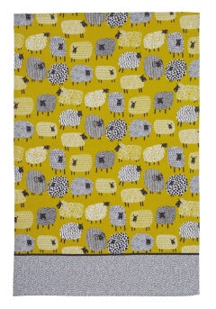 Ulster Weavers cotton tea towel with a Dotty Sheep print in mustard yellow and a grey hem