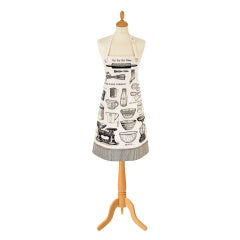 Ulster Weavers Baking biodegradable oil cloth apron with an illustrated kitchen print, shown on a mannequin