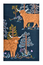 Ulster Weavers Connie the Cow cotton tea towel with Highland cows and trees on dark blue