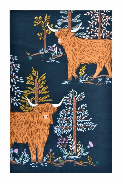Ulster Weavers Connie the Cow cotton tea towel with Highland cows and trees on dark blue