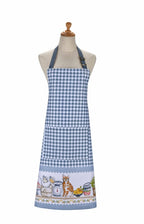 Ulster Weavers Pantry Cats cotton apron in blue gingham with a hem of cats and kitchenware, shown on a mannequin