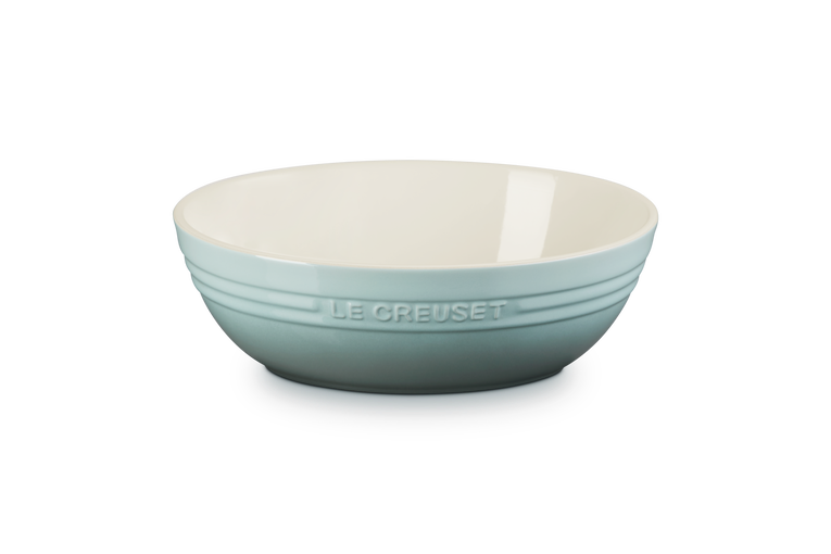 Le Creuset stoneware oval serving bowl in sea salt blue-green with a ridged exterior