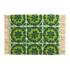 Sage x Clare Gabriella bath mat with a green tile-pattern print and fringed edges