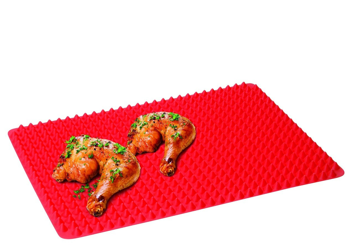 Avanti silicone fat reducing cooking mat in red with a raised pyramid surface, shown with roasted chicken pieces