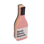 White Magic Scrubbly dish sponge shaped like a wine bottle with Rose. Rinse. Repeat. lettering