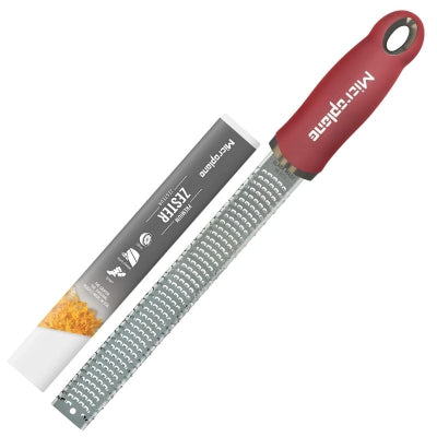 Microplane Premium Zester grater with a red handle, shown beside its retail packaging