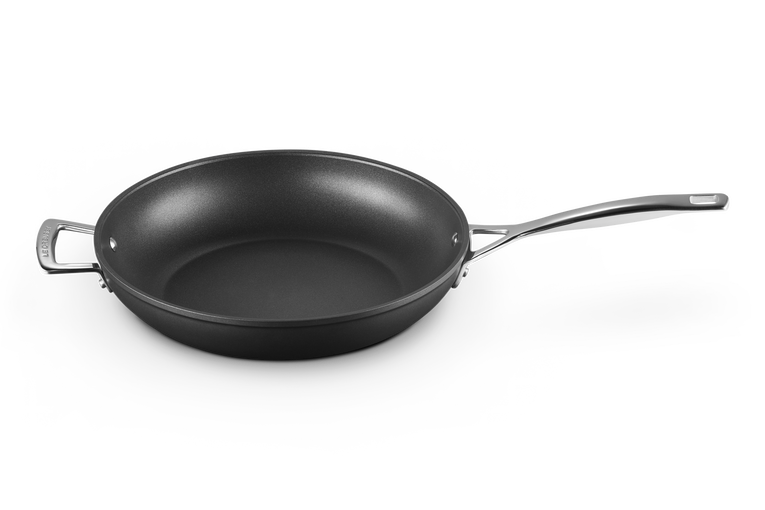 Le Creuset TNS deep frying pan in black non-stick with a long handle and a small helper handle