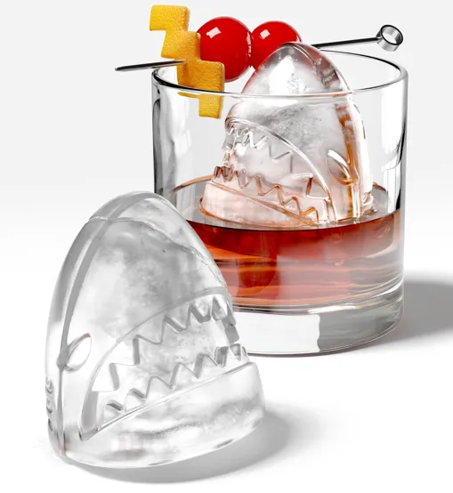 Zoku Shark ice mould set, a clear shark head ice ball beside a mould and a whisky glass with a cherry