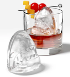 Zoku Shark ice mould set, a clear shark head ice ball beside a mould and a whisky glass with a cherry