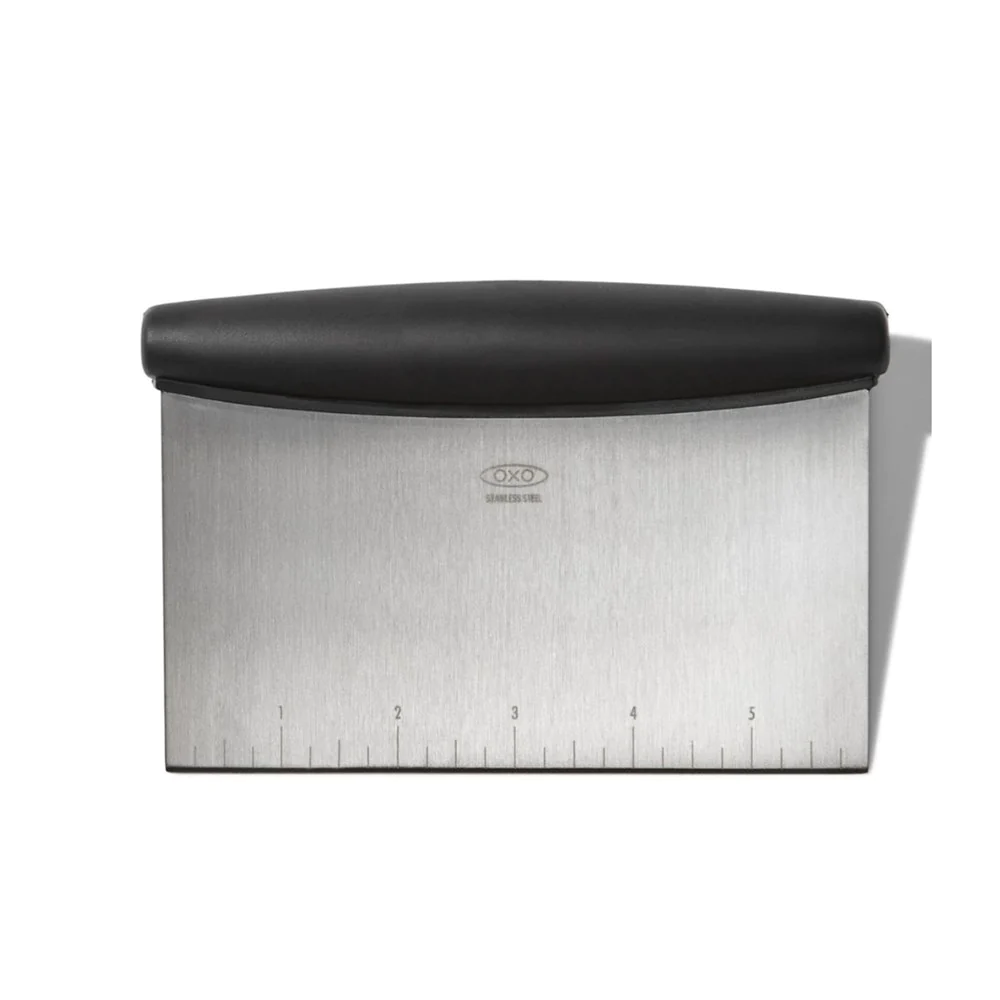 OXO Good Grips multi-purpose scraper and chopper with a stainless steel blade, measurement marks and a black handle