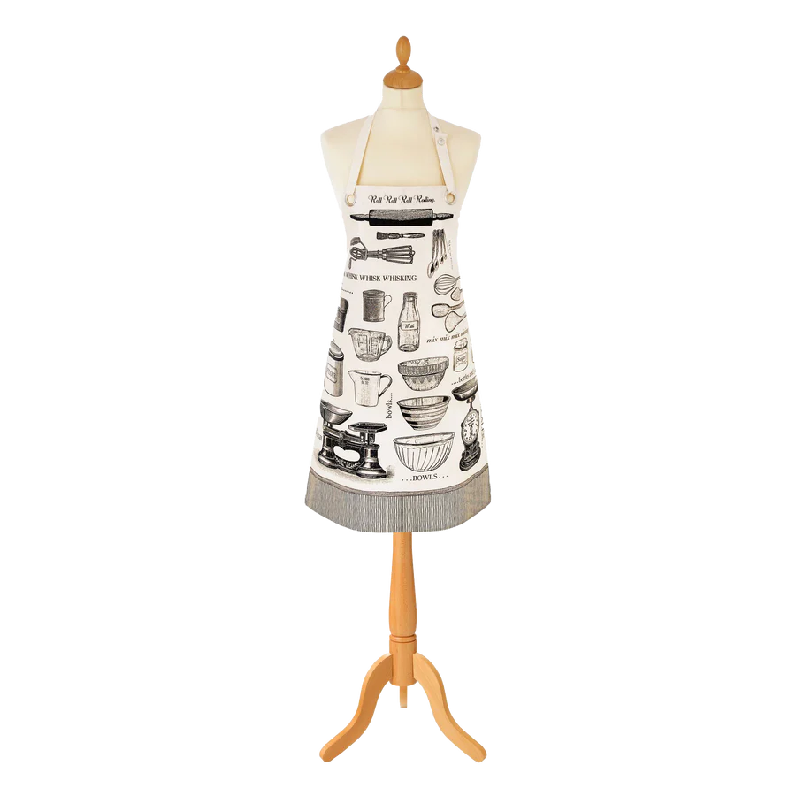 Ulster Weavers oil cloth apron with a black and white baking utensils print, shown on a dress form