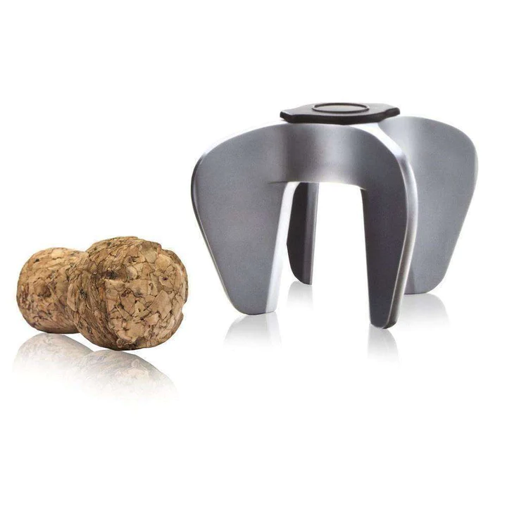 Vacu Vin champagne opener in brushed steel, shown removing a cork