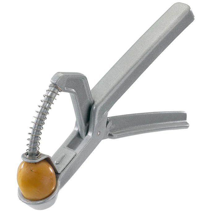 Westmark olive stoner, a grey metal hand-squeeze tool pitting a green olive