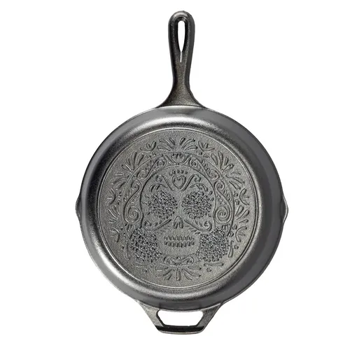 Lodge Sugar Skull skillet in black cast iron with an embossed skull design