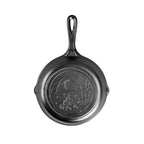 Lodge Wanderlust tent skillet in black cast iron with an embossed camp scene