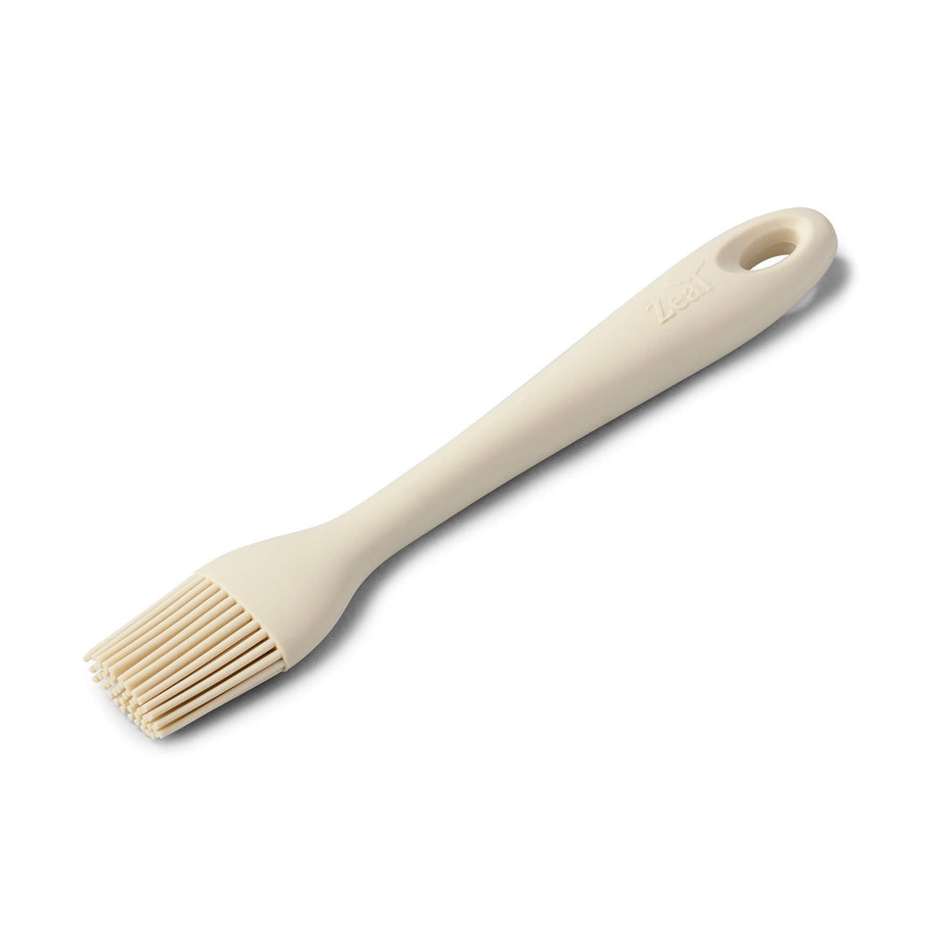 Zeal silicone basting brush in cream with a long handle and silicone bristles